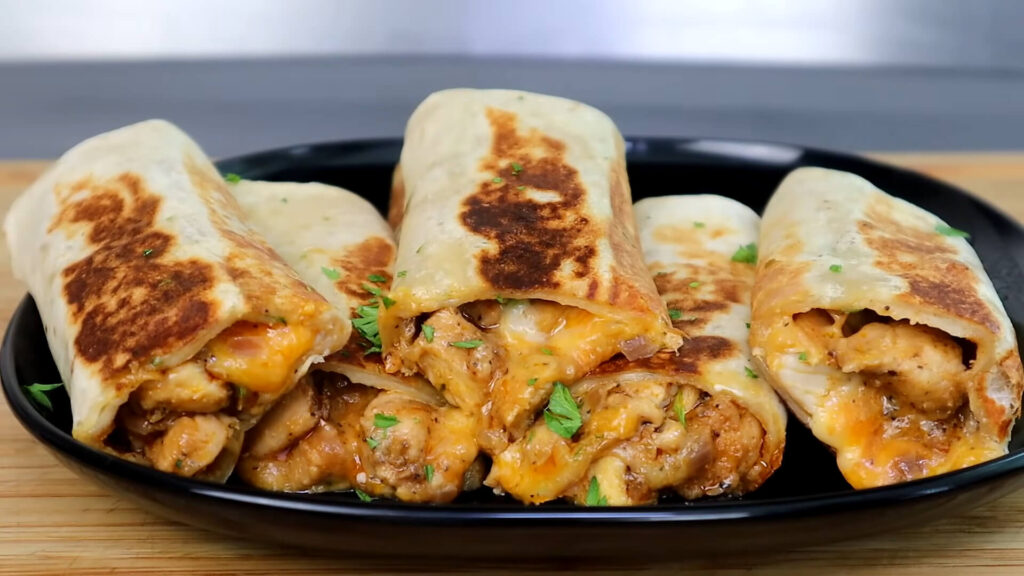 Cheesy garlic chicken wrap with fresh ingredients wrapped in a soft tortilla